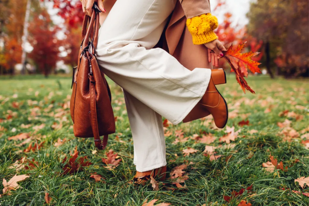 Women wearing a brown leather wide shoed heel in the grass.